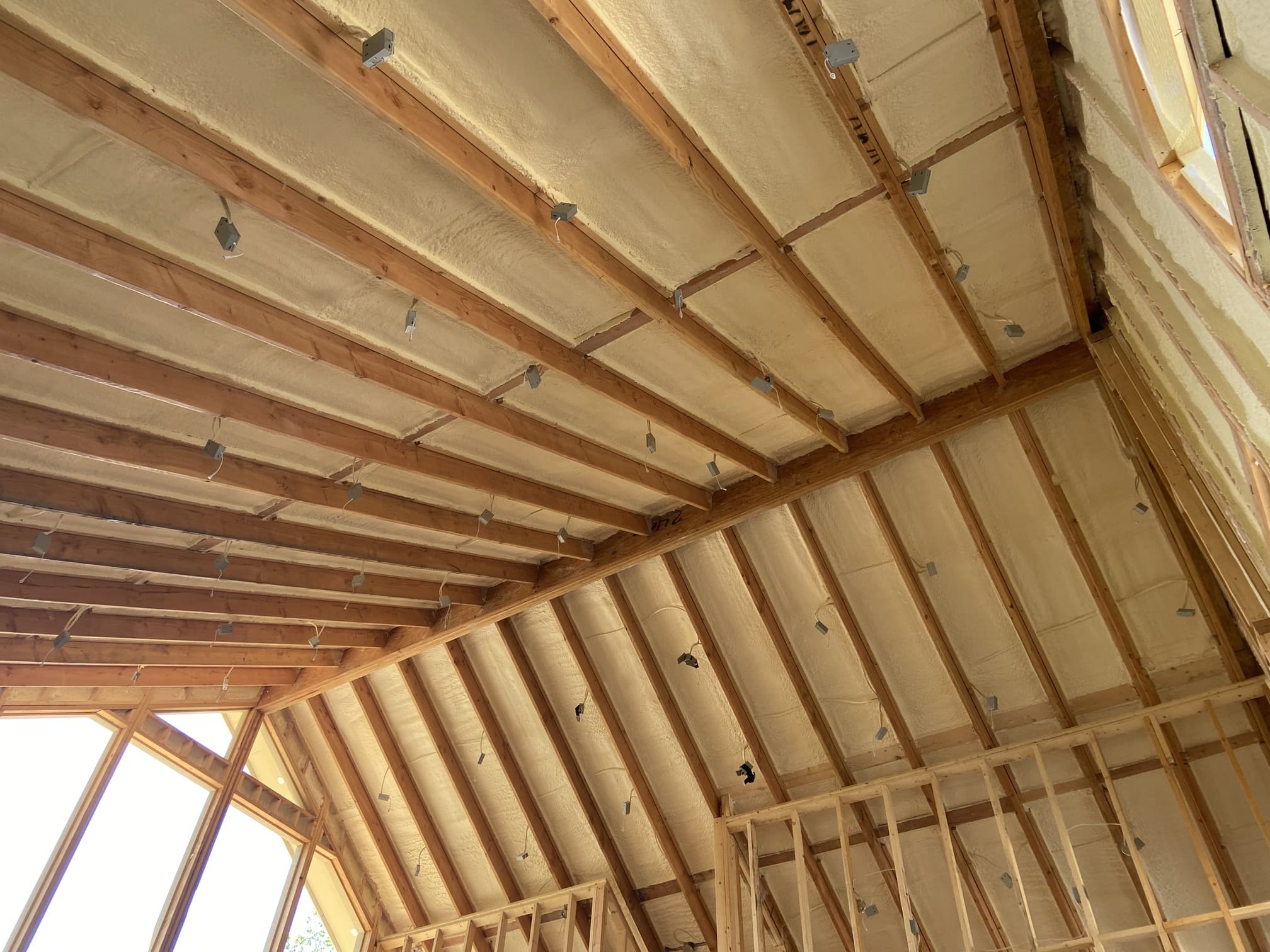 Spray foam insulation applied to an attic roofline