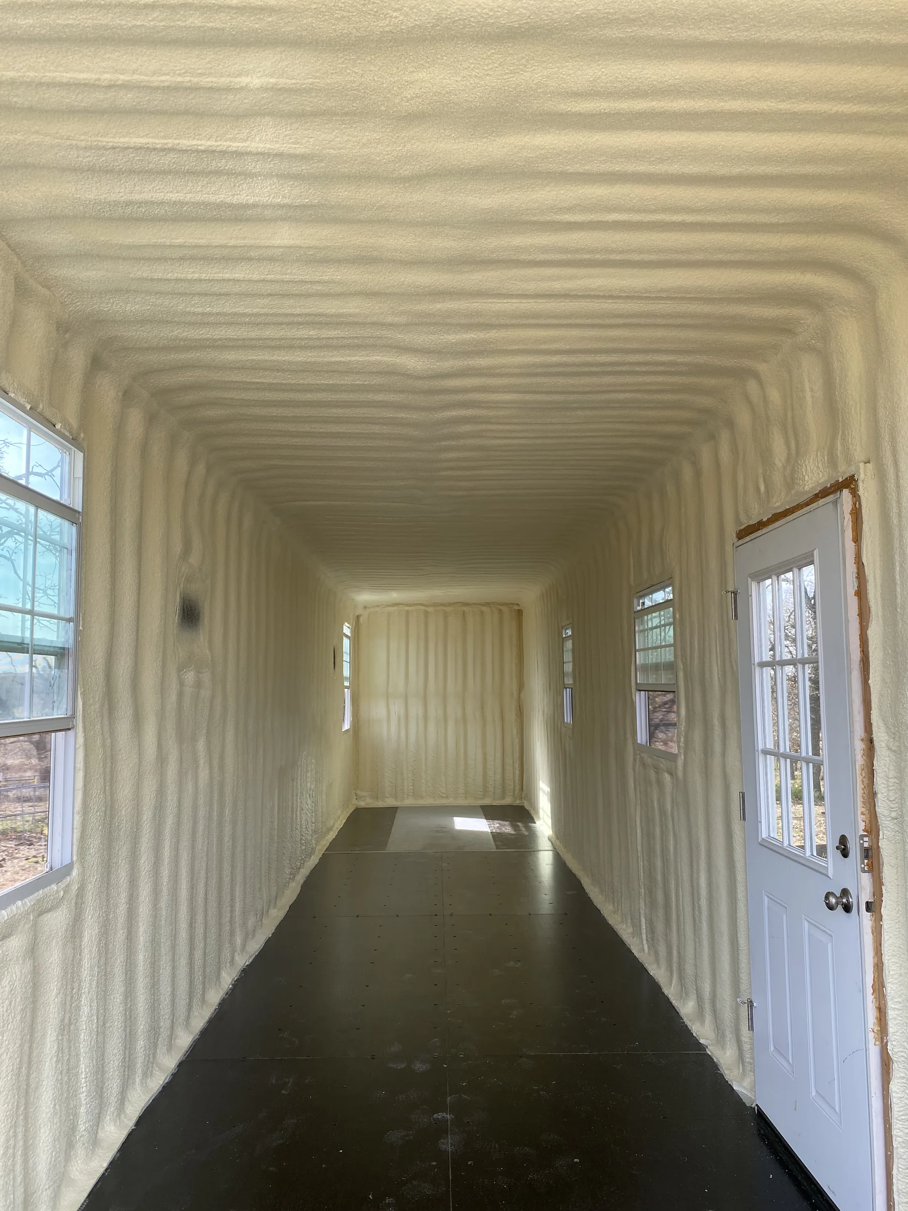 Alvarado cargo-container tiny home after closed-cell spray foam