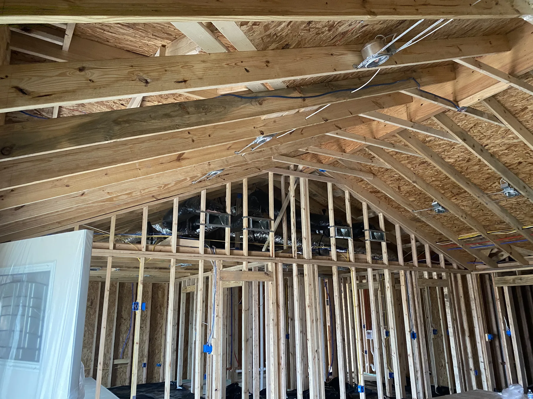 Blum new-home roofline before open-cell spray foam coverage